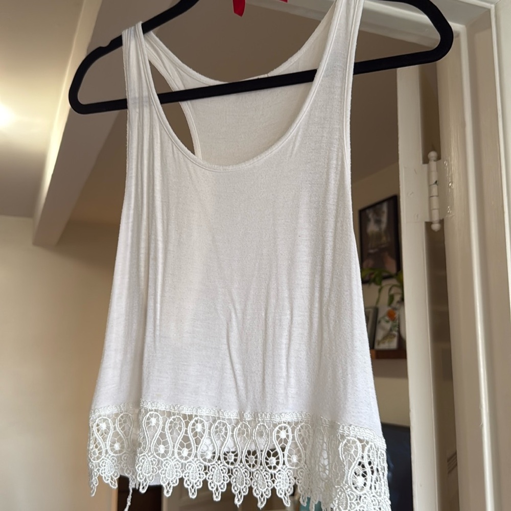White tank top with lace trim detailing on bottom 
Fits like S